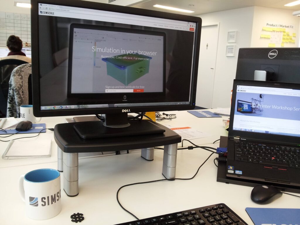 Picture of a desktop showing SimScale on two screens