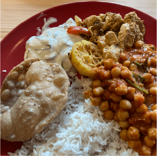 red plate of indian curry and rice