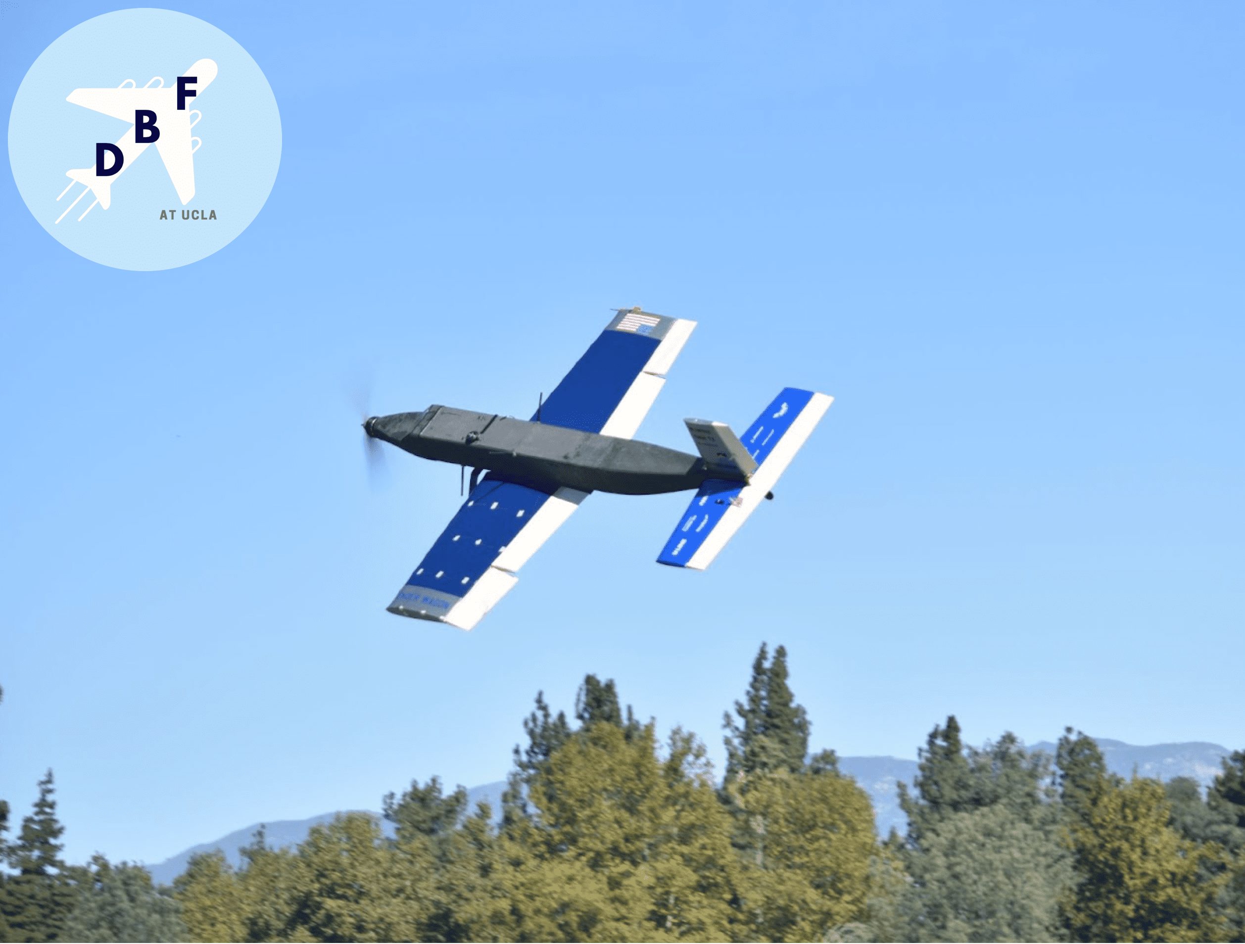 A blue and gray aircraft prototype in flight (developed by DBF at UCLA)